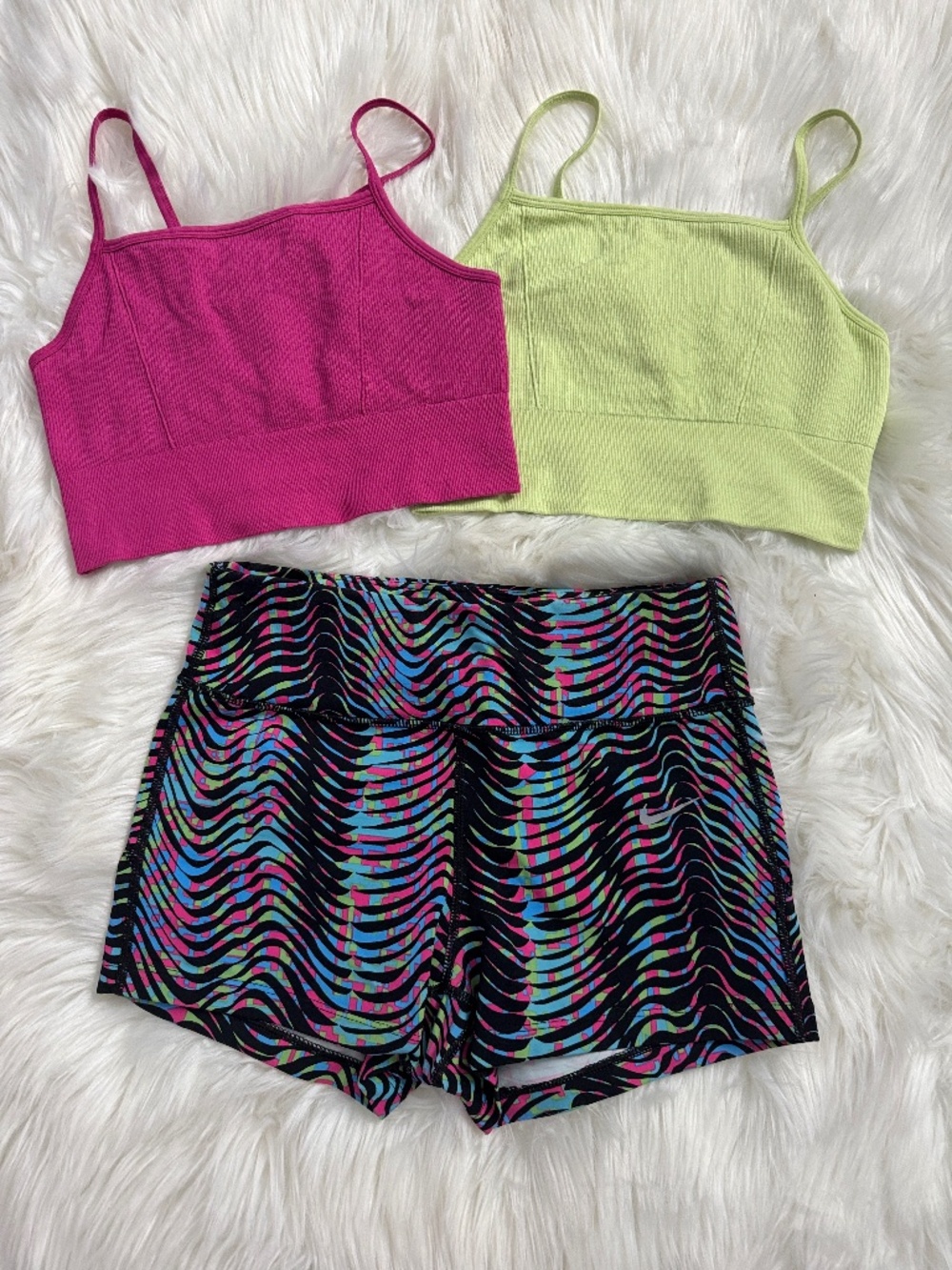 2 Fabletics bras with Nike running shorts